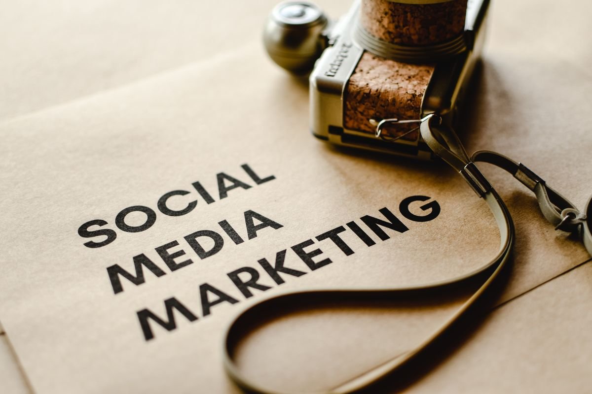 Social media marketing text on a desk with a camera — social media marketing and content service