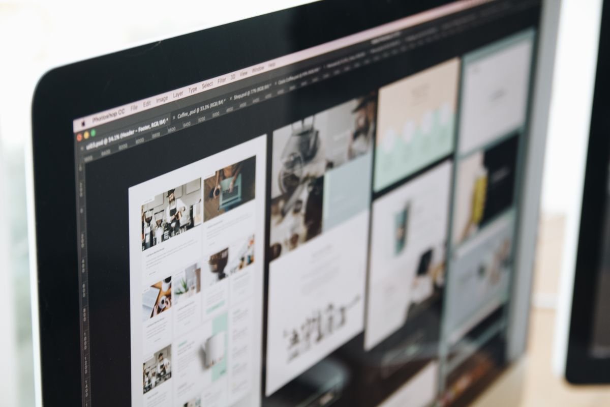 Website design mockups displayed on a designer's screen — custom website design and development service